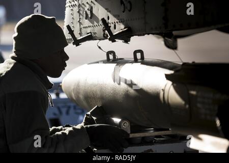 Staff Sgt. Tayrell Washington, 74th Aircraft Maintenance Unit weapons load team chief, guides a Mark 82 general purpose bomb into position underneath an A-10C Thunderbolt II during Green Flag-West 17-03, Jan. 24, 2017, at Nellis Air Force Base, Nev. Weapons Airmen enabled joint force training during the two-week exercise by loading weapons, inspecting jets and maintaining munitions systems. Some of the live munitions included the Mark 82 and 84 general purpose bombs, high-explosive incendiary 30mm rounds and the 500 pound GBU-12 Paveway II laser-guided bomb. Stock Photo