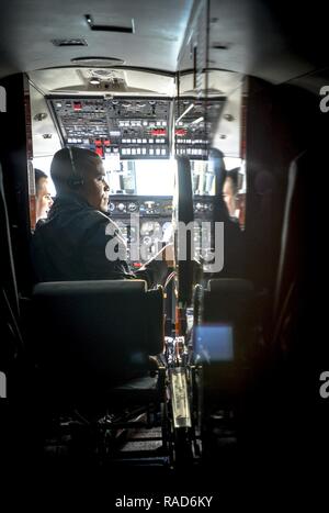 Tech. Sgt. Vanessa Schook, 99th Airlift Squadron flight attendant, performs a pre-flight safety inspection on a C-20B at Joint Base Andrews, Maryland, Jan. 27, 2017. FAs are safety experts, customs specialists and culinary artists, often preparing meals from scratch at 30-to-40,000 feet, while ensuring the safety of the crew and passengers at all times. Stock Photo