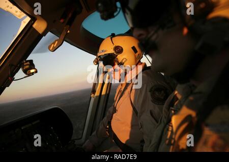 Air interdiction agents with the U.S. Customs and Border Protection, Air and Marine Operations, looks out from an A-Star helicopter over the Houston Air Unit in Conroe, Texas, as CBP prepares to provide security during this coming weekend's Super Bowl 51, Jan. 30, 2017. U.S. Customs and Border Protection Stock Photo