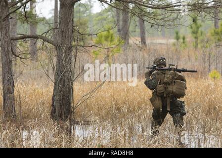 U.S. Marine Corps Pfc. Ethan H. Porter, machine gunner with Fox Company, 2nd Battalion, 6th Marine Regiment (2/6), 2nd Marine Division (2d MARDIV), carries an M240B machine gun to the next fighting position during a 2/6 field training exercise on Camp Lejeune, N.C., Jan. 26, 2017. The purpose of the exercise was to develop skills learned from previous field training while integrating mechanized vehicle assets in order to maintain combat proficiency. Stock Photo