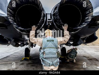 U. S. Air Force Col. David Brynteson, 332nd Expeditionary Operations Group commander, checks the engines on an F-15E Strike Eagle Jan. 27, 2016, in Southwest Asia. Brynteson was preparing to fly his last sortie in theater. Stock Photo