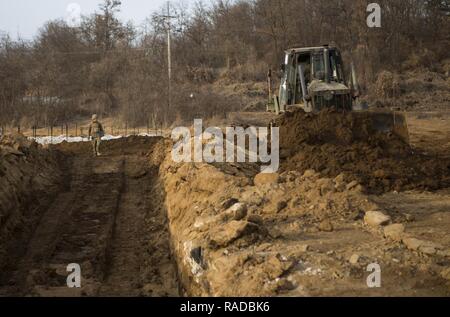 U.S. Marines with Alpha Company, 9th Engineer Support Battalion, 3rd Marine Logistics Group, use Bulldozers to dig tank ditch during the exercise Korean Marine Exchange Program (KMEP) 17-8 on New Mexico Range, South Korea, January 28, 2017. KMEP is an annually scheduled training event designed to enhance to improve the tactical interoperability and camaraderie of the Republic of Korea (ROK) and U.S. Marines by allowing them to work side-by-side as a cohesive unit. The alliance between America and the Republic of Korea has grown even stronger based upon the shared interests and values of both n Stock Photo