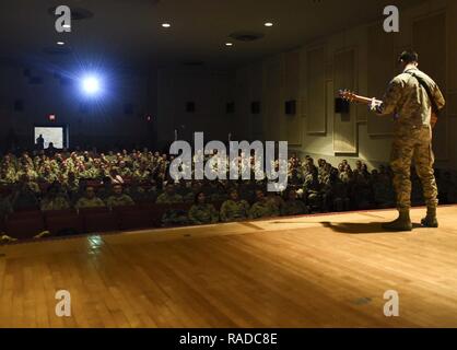 Senior Airman James Pratt, a heavy equipment operator assigned to the 28th Civil Engineer Squadron, performs John Mayer's 'Age of Worry' in front of the 28th Mission Support Group inside the base theater during their annual awards ceremony, Jan. 26, 2017, at Ellsworth Air Force Base, S.D. Four days later, Pratt was announced the Air Force Entertainer of the year and congratulated by Col. Gentry Boswell, the commander of the 28th Bomb Wing, in a coining ceremony. Stock Photo