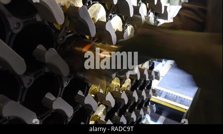 A 105 mm shell is loaded into a storage rack on an AC-130J Ghostrider ...