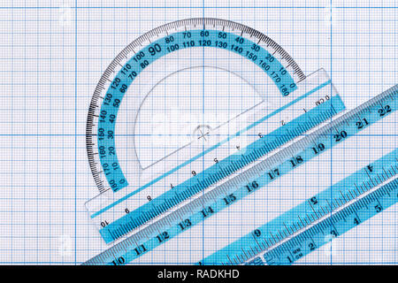 Backgrounds and textures: group of transparent plastic rulers, arranged on graph paper, educational abstract Stock Photo