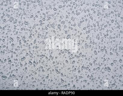 Abstract water drops on a shiny metal background. Stock Photo