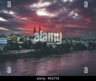 Burning sunset over the Rhine and Münster in Basel, Switzerland during the Autumn Fare