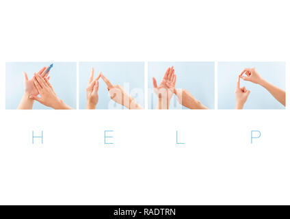 The word HELP in British sign language on an isolated black background ...