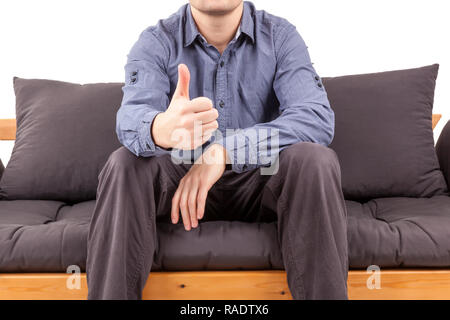Businessman on sofa showing thumbs up. Mentor and leadership concept. Stock Photo