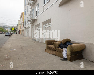 Homeless man sleeping on sofa Stock Photo
