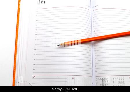 opened notepad and pencil on a white close up shoot Stock Photo