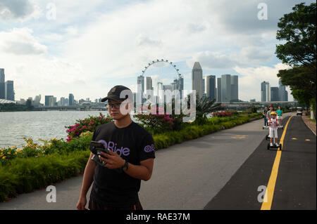 26.12.2018, Singapore, Republic of Singapore, Asia - People are riding on Segway electric scooters along the waterside at Gardens By The Bay East. Stock Photo