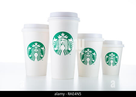 CHIANG MAI, THAILAND - 1 JANUARY 2019 - Starbucks white take home cups in various sizes line up on white table against white background in Chiang Mai, Stock Photo