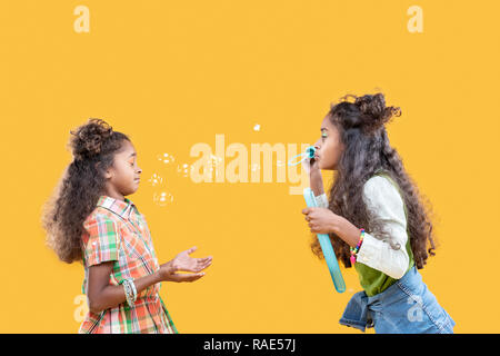 Delighted cute girl standing opposite her sister Stock Photo