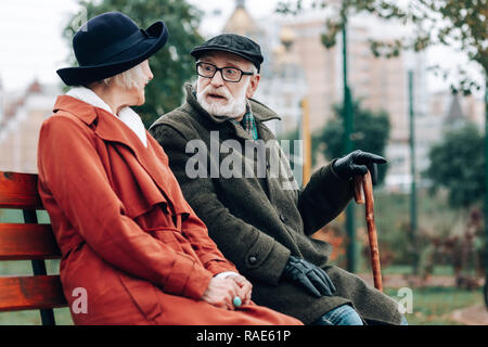 Emotional senior male person staring at his wife Stock Photo