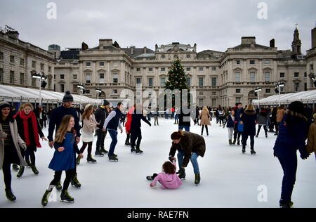 People skating on ice at the Somerset House Christmas Ice Rink. London, United Kingdom, December 2018. Stock Photo