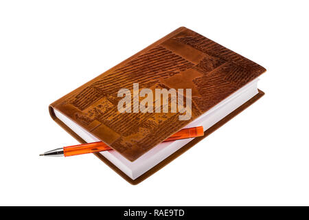 Brown leather notebook with orange ballpoint pen isolated on white background Stock Photo