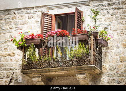 Beautiful vintage balcony with colorful flowers and stone wall Stock ...