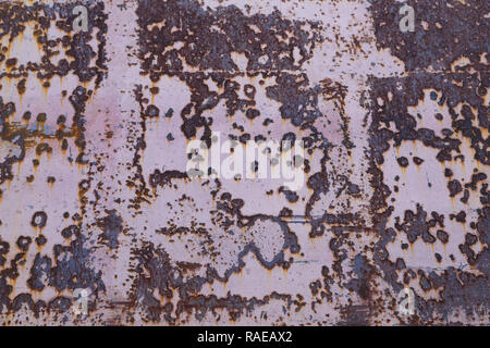 Red painted metal surface with large rust stains as background Stock Photo