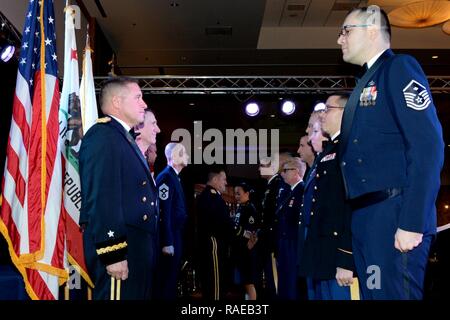 Winners of this year's Outstanding Soldier/Airman of the Year competition stand at attention as California's Adjutant General Major General David Baldwin congratulates each member individually. 146th Airlift Wing's Master Sgt. Josh Baker stands front right and received the award in the First Sergeant category. Stock Photo