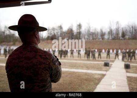 U.S. Marine Corps Capt. Jerry Dalton, company commander for Marksmanship Training Company, Weapons Training Battalion (WTBn), acts as a range safety officer during the Combat Pistol Program for Marines attending The Basic School aboard MCB Quantico, Va., Jan. 20, 2017. The purpose of WTBn is to serve as the Marine Corps proponent for all facets of small arms combat marksmanship and to be the focal point for marksmanship doctrine, training, competition, equipment, and weapons. Stock Photo