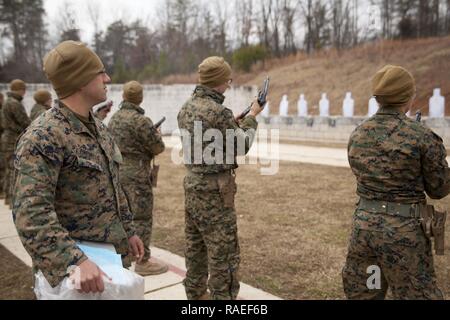 U.S. Marines assigned to The Basic School conduct the Combat Pistol Program at Weapons Training Battalion (WTBn) aboard MCB Quantico, Va., Jan. 20, 2017.  The purpose of WTBn is to serve as the Marine Corps proponent for all facets of small arms combat marksmanship and to be the focal point for marksmanship doctrine, training, competition, equipment, and weapons. Stock Photo
