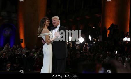 United States President Donald J. Trump and First Lady Melania Trump dances in the center of the stage during the Salute to Our Armed Services Ball at the National Building Museum, Washington, D.C., Jan. 20, 2017. The event, one of three official balls held in celebration of the 58th Presidential Inauguration, paid tribute to members of all branches of the armed forces of the United States, as well as first responders and emergency personnel. Stock Photo