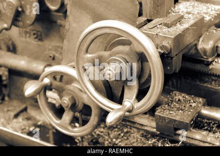 Close-up of the control adjustment wheels on an old industrial lathe with toning Stock Photo