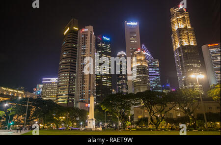 Dalhousie Obelisk at night with Raffles Place in the background at night, Singapore Stock Photo