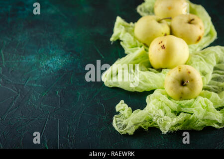 Fresh green apples on dark green background Stock Photo