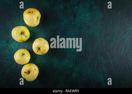 Fresh green apples on dark green background Stock Photo