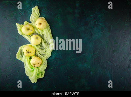 Fresh green apples on dark green background Stock Photo