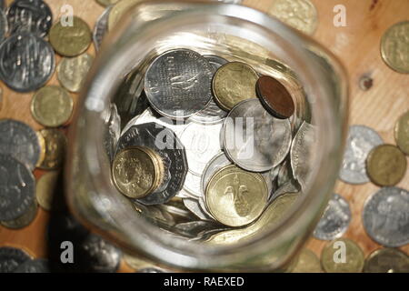 spare change in a glass jar Stock Photo