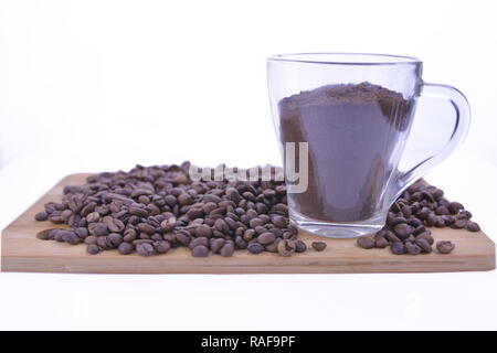 coffee beans and sweets on the table, cup of coffee. Stock Photo