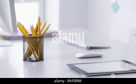 Graphite pencils in a metal grid-container. Concept Stock Photo