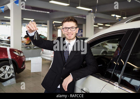 Cheerful man with keys of new car Stock Photo