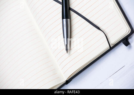 White notepad notebook lines elegant pen grey wooden background Stock Photo