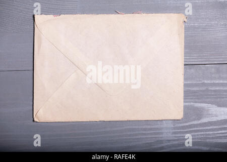 Old vintage elegant business pen letter sheet paper grey wooden background flatlay Stock Photo