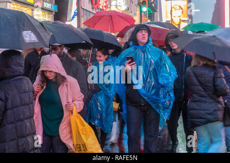 Hordes of tourists descend on a rainy Times Square in New York on Friday, December 28, 2018 in anticipation of New Year's Eve.  There is a 70 percent chance of rain starting the afternoon of December 31 with the precipitation continuing into January 1. (Â© Richard B. Levine) Stock Photo