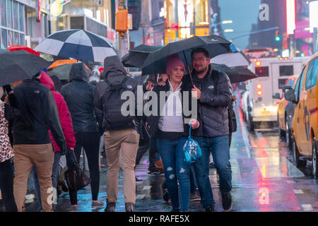 Hordes of tourists descend on a rainy Times Square in New York on Friday, December 28, 2018 in anticipation of New Year's Eve.  There is a 70 percent chance of rain starting the afternoon of December 31 with the precipitation continuing into January 1. (Â© Richard B. Levine) Stock Photo