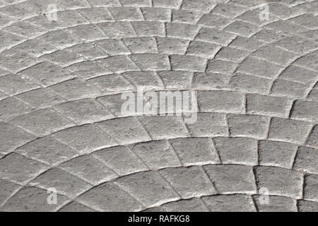 The road is paved with gray sets with solar modulations. Road surface. Stock Photo