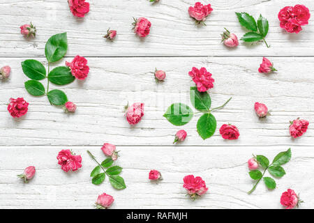 Flowers composition made of pink rose flowers with green leaves. Valentine's day background. Flat lay, top view Stock Photo