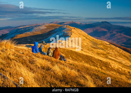 Wetlina, Poland, November 12, 2011:Group of people enjoy the sunset over Bieszczady Mountains, south east Poland Stock Photo