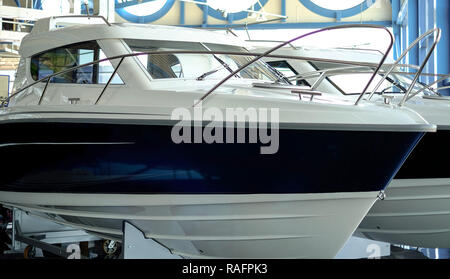 Promenade. Motor boat for sale in the store. Located on a wheeled cart. Stock Photo