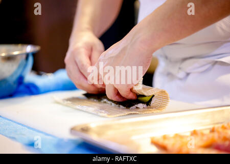 chef hands preparing japanese food, chef making sushi, Preparing Sushi roll Stock Photo