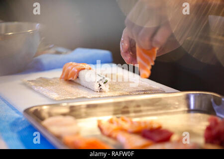 chef hands preparing japanese food, chef making sushi, Preparing Sushi roll Stock Photo