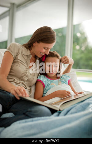 Mother reading young daughter a story in hospital. Stock Photo