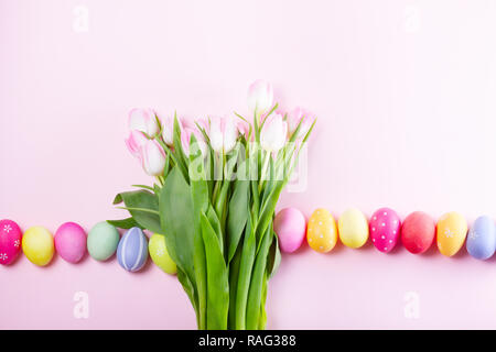 Pink fresh tulips with easter eggs row with copy space Stock Photo