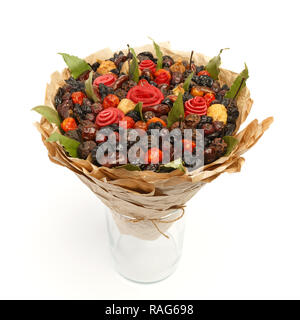 Unique gift in the form of a bouquet consisting of various dried fruits, bay leaves packed in kraft paper on a white background Stock Photo