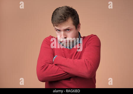 Miserable sad attractive european man being offended and upset Stock Photo